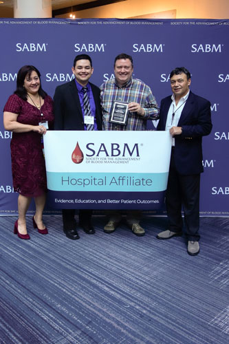 Representatives from SABM awarding a hospital affiliate certification to representatives from Helen DeVos Children's Hospital