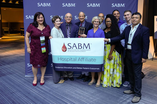 Representatives from SABM awarding a hospital affiliate certification to representatives from Johns Hopkins Hospital