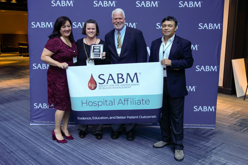 Representatives from SABM awarding a hospital affiliate certification to representatives from Oregon Health and Science University